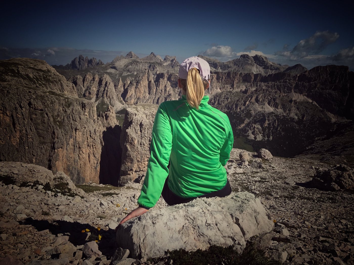 Christina Kehl on a rocky plateau looking out at jagged peaks