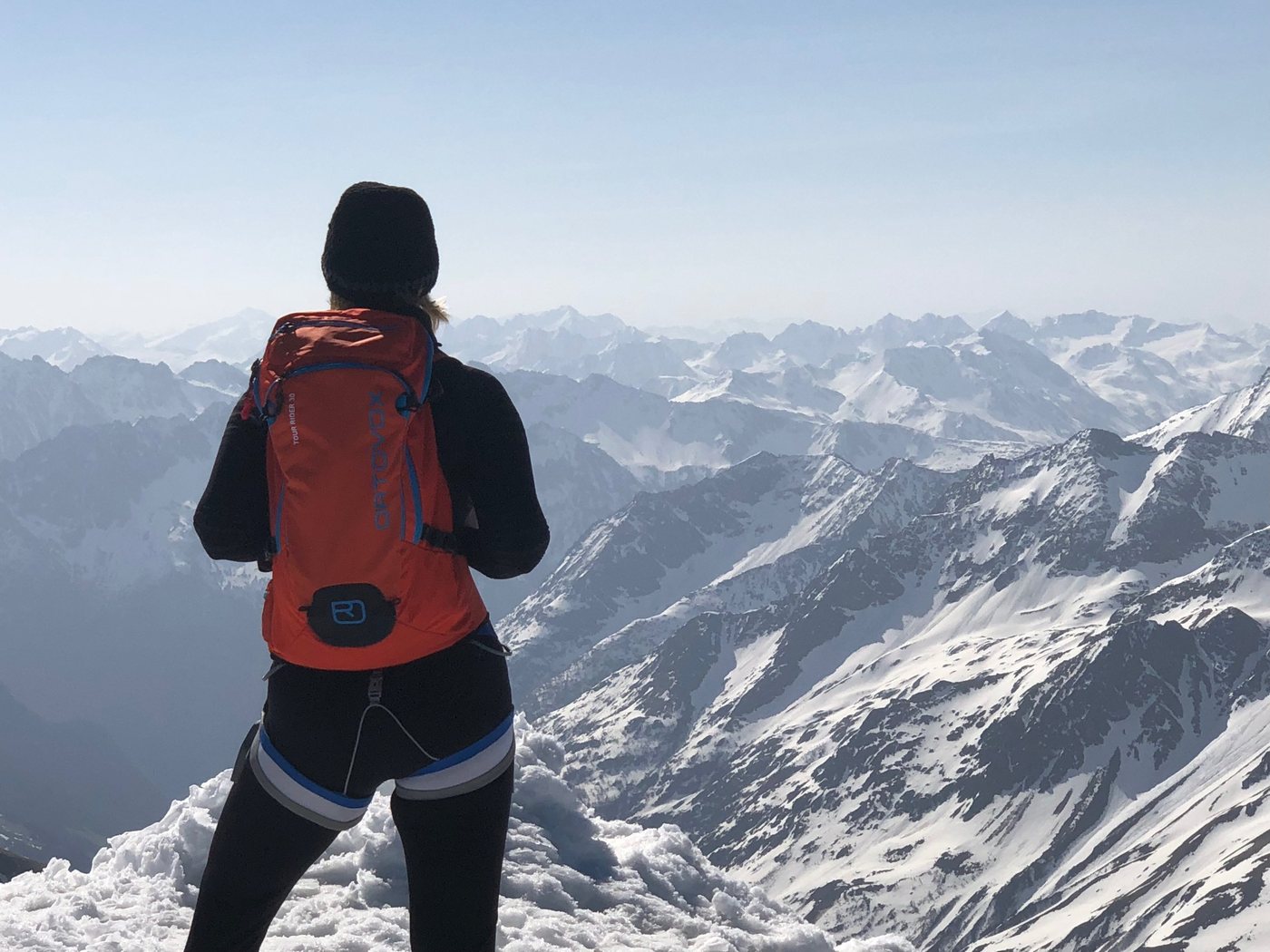 Christina Kehl on a snowy summit looking out over the Alps