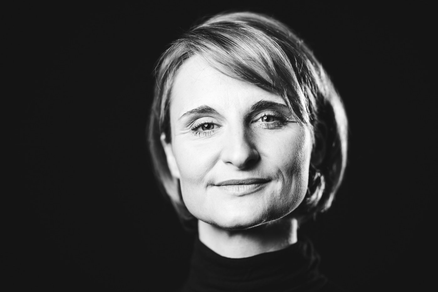 Black-and-white portrait of Christina Kehl against a dark background