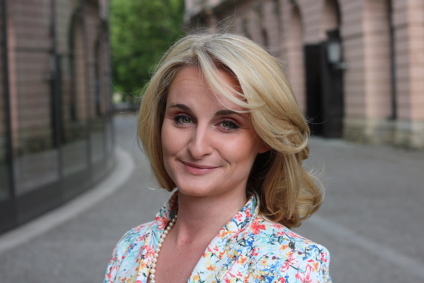 Portrait of Christina Kehl in a floral blazer outdoors