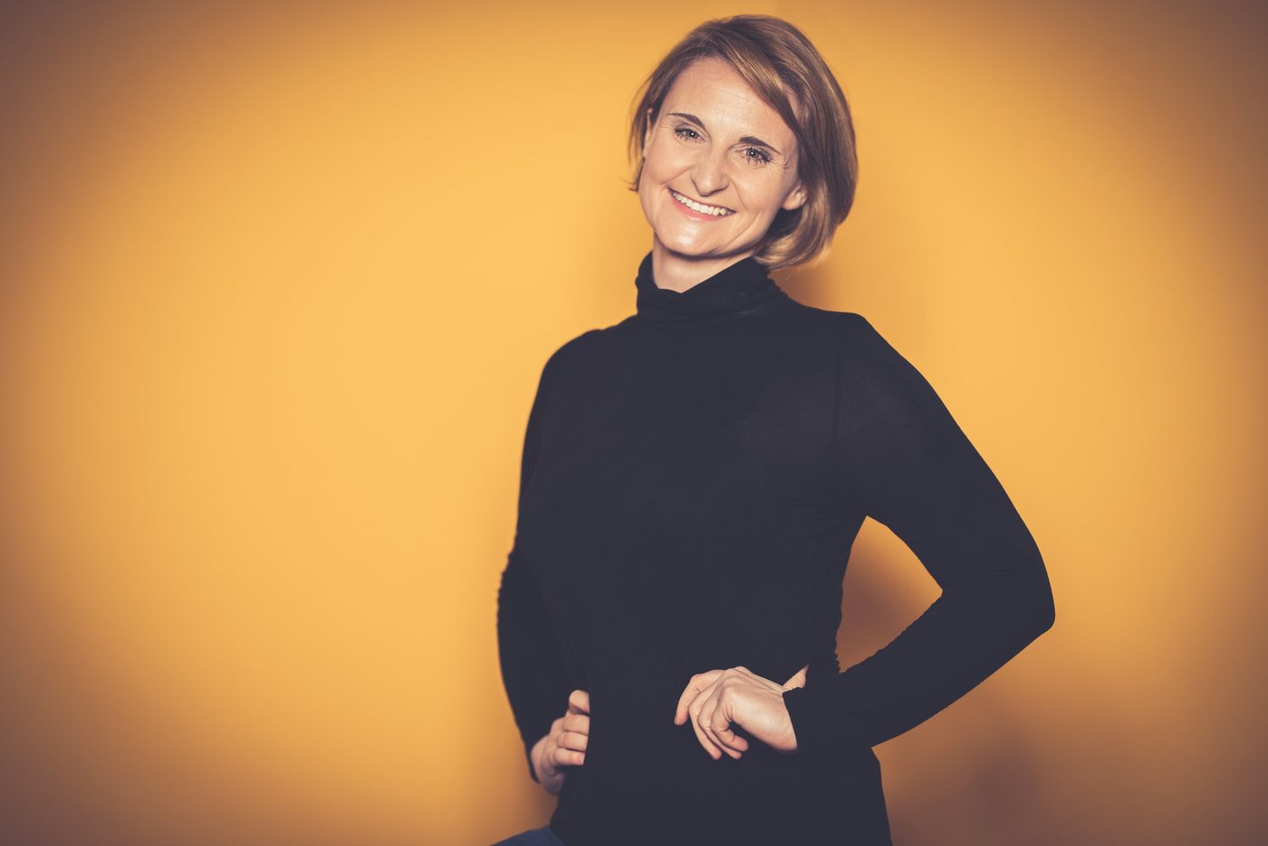 Portrait of Christina Kehl against an orange background
